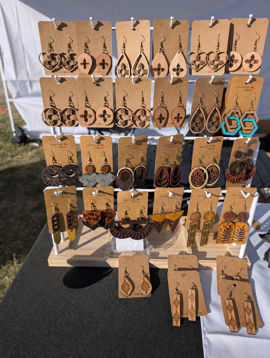 Creations of LNC earrings displayed outdoors